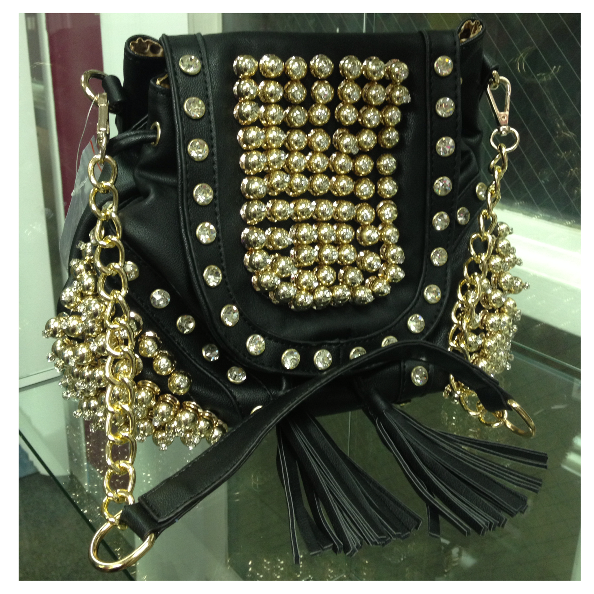 This item can be worn as a backpack    and has extra straps inside purse Black and gold leather handbag with clear crystals throughout  size  medium  $95